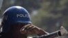 A stone hits the gun of a UN peacekeeper from Nigeria during a protest in Port-au-Prince, Haiti, Thursday, Nov. 18, 2010.