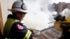 Fire fighters put out a fire on the roof of a building near the Russian market in Phnom Penh March 18, 2009. Twelve houses were destroyed in the blaze but no one was injured, police said. It is not known how the fire was started. REUTERS/Chor Sokunthea 