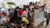 FILE: Cambodian migrant workers get off from a Thai truck upon their arrival from Thailand at a Cambodia-Thai international border gate in Poipet, Cambodia, Tuesday, June 17, 2014. (AP Photo/Heng Sinith)