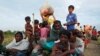 Exhausted Rohingya refugees wait to be taken to a refugee camp after crossing the Naf river at the Bangladesh-Myanmar border in Palang Khali, near Cox’s Bazar, Bangladesh, Nov. 2, 2017.