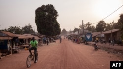 FILE - A man rides a bike in the main avenue of the town of Paoua, northwestern Central African Republic, Dec. 27, 2017. 