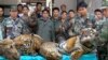 FILE - Thai Navy officers and forestry officials display seized dead tigers, leopards and pangolins in That Phanom district of Nakhon Phanom province, northeastern Thailand, Jan. 29, 2008. 