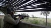 A Pakistani paramilitary soldier is seen inside a bunker monitoring an area on the border of Pakistan and India in Dhamala Hakimwala, Pakistan, Oct. 8, 2014.