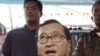 Cambodian opposition party leader Sam Rainsy, stands in front of the municipal court in Phnom Penh.