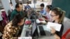 Locals sit for registering their names during a voter registration process of the National Election Committee (NEC) in Phnom Penh, Cambodia, Thursday, Sept. 1, 2016. 