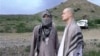 In this image taken from video obtained from Voice of Jihad Website, Sgt. Bowe Bergdahl (R) stands with a Taliban fighter in eastern Afghanistan.