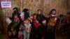 Rohingya Muslim refugee women with their children wait at a nutrition center to collect the diet for their children at Balukhali refugee camp 50 kilometres (32 miles) from, Cox's Bazar, Bangladesh, Jan. 23, 2018. 