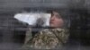 A detained Ukrainian serviceman and crew member of one of Ukrainian naval ships recently seized by Russia's FSB security service looks out of a minibus window outside a court building in Simferopol, Crimea, Nov. 28, 2018.