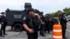 Nassau County special operations officers stand in a parking lot before Republican presidential nominee former President Donald Trump arrives to speak at a campaign event at Nassau Coliseum in Uniondale, New York, Sept. 18, 2024.