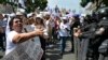 A woman confronts police officers as employees of the Judiciary, who are on an indefinite strike, protest in front of the Supreme Court of Justice in Mexico City on August 25, 2024.